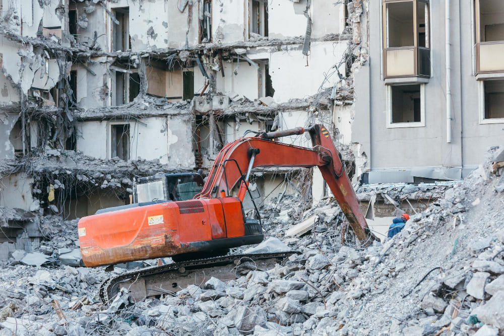 excavator crusher bucket  on site crushing debris