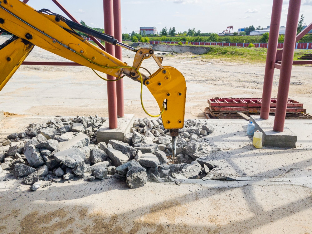 image of a skid steer hydraulic breaker attachment working